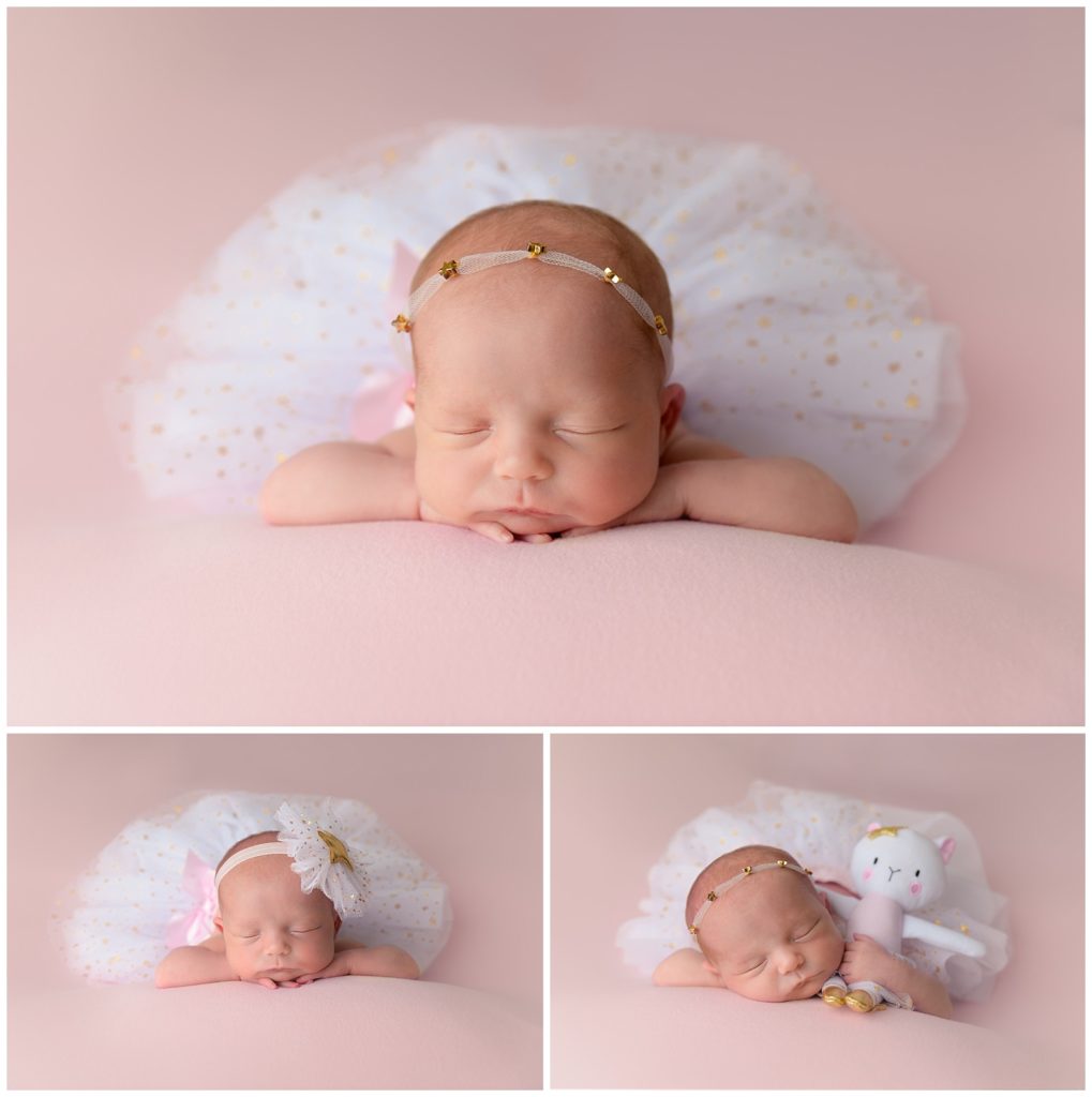 newborn baby girl with tutu on pink backdrop
