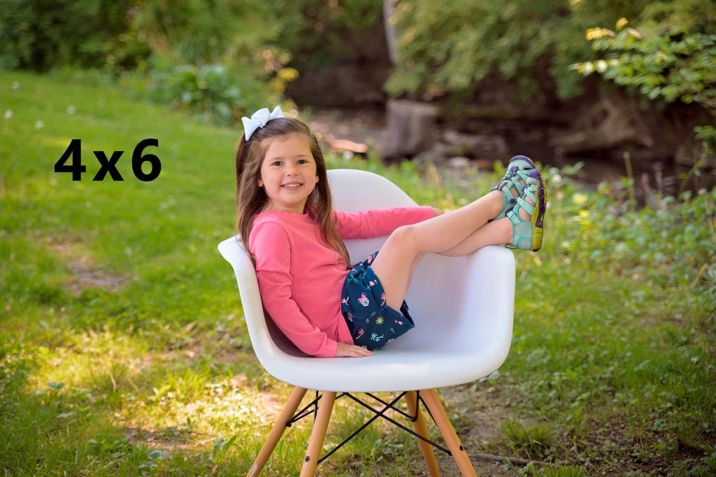 Girl sitting in white chair outdoor mini session