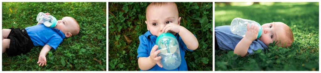 four month old baby with bottle laying in grass