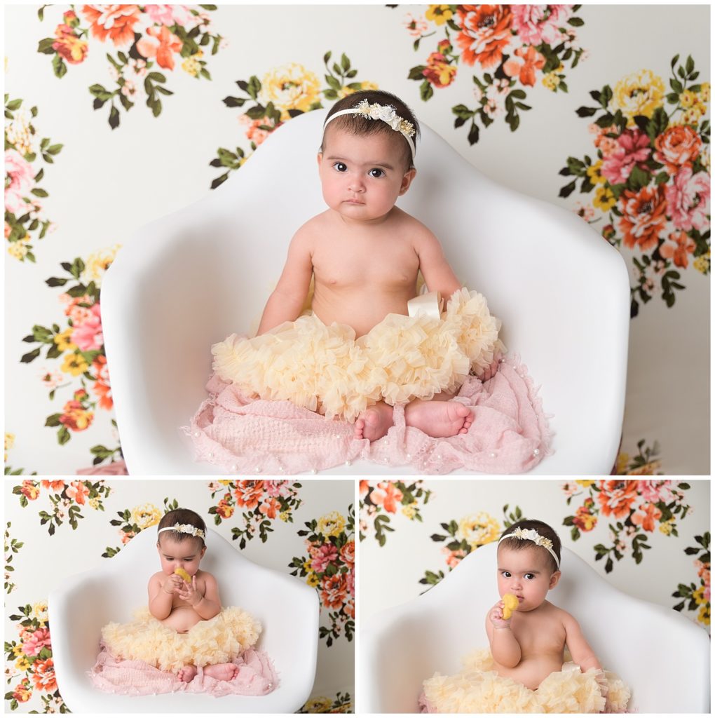 six month old baby girl in a tutu and a flower background
