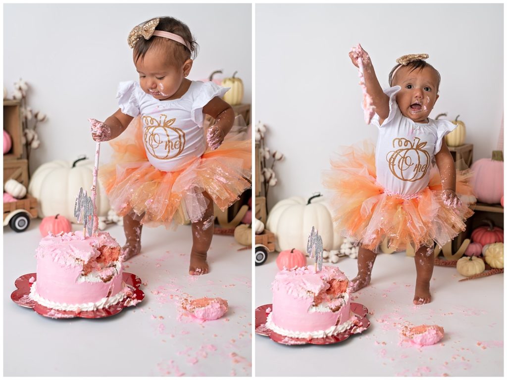 baby girl standing up eating cake