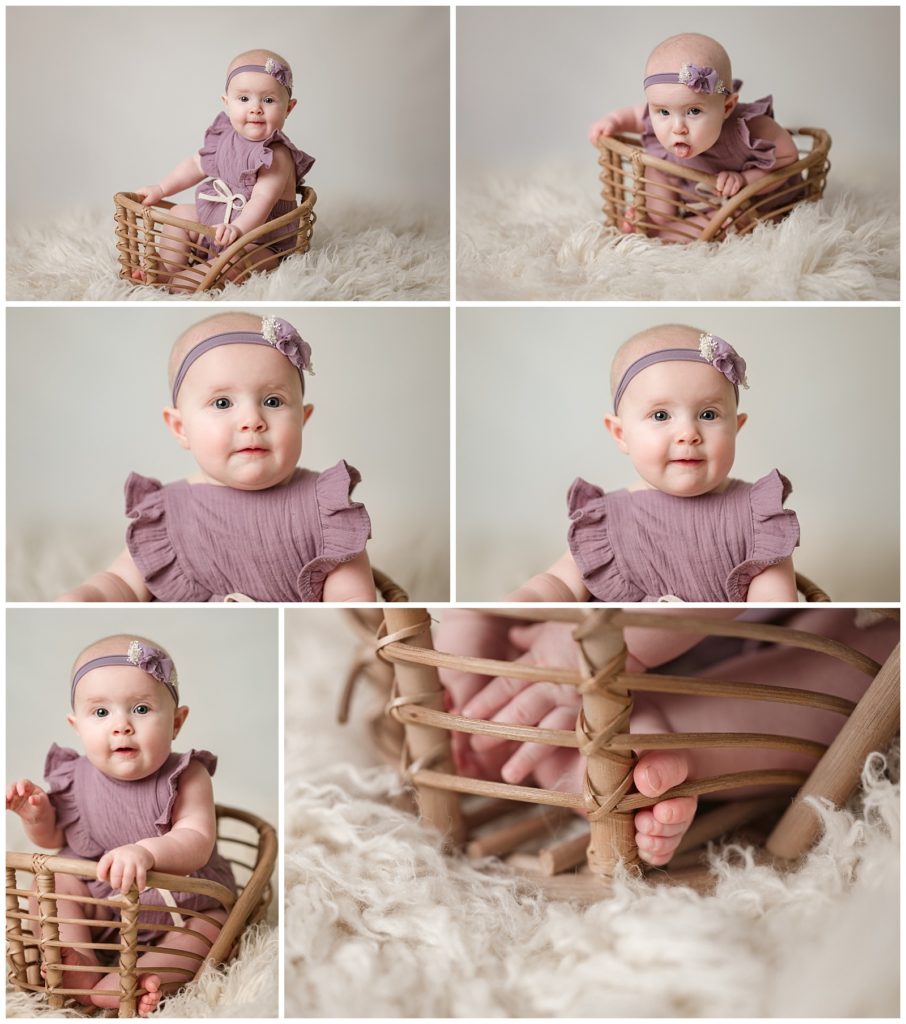 baby girl in a basket in a purple romper