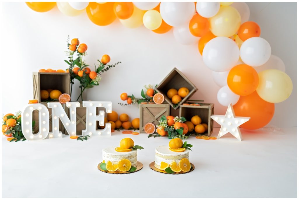 orange themed twin cake smash session
