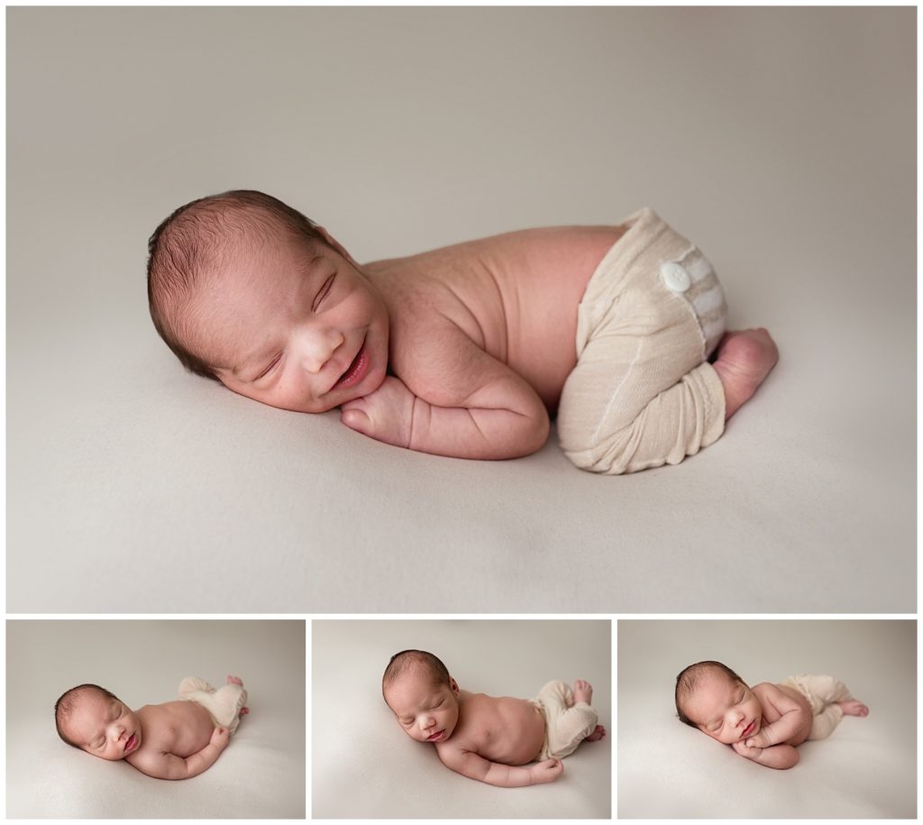 newborn baby boy smiling during his photography session