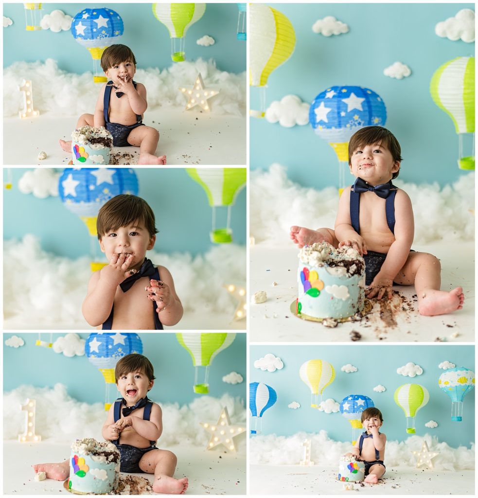 one year old boy cake smash with his foot in a cake and a hot air balloon theme