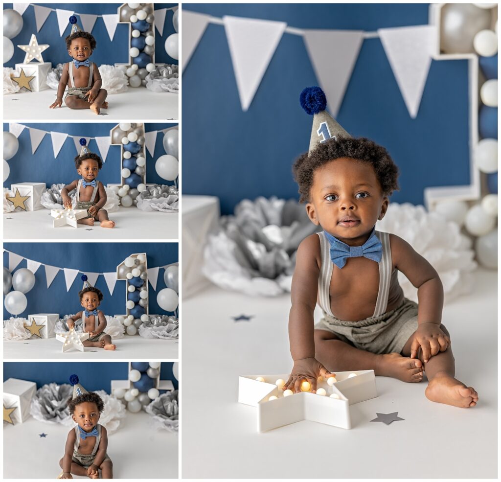 baby boy turns one with navy backdrop and white accents.