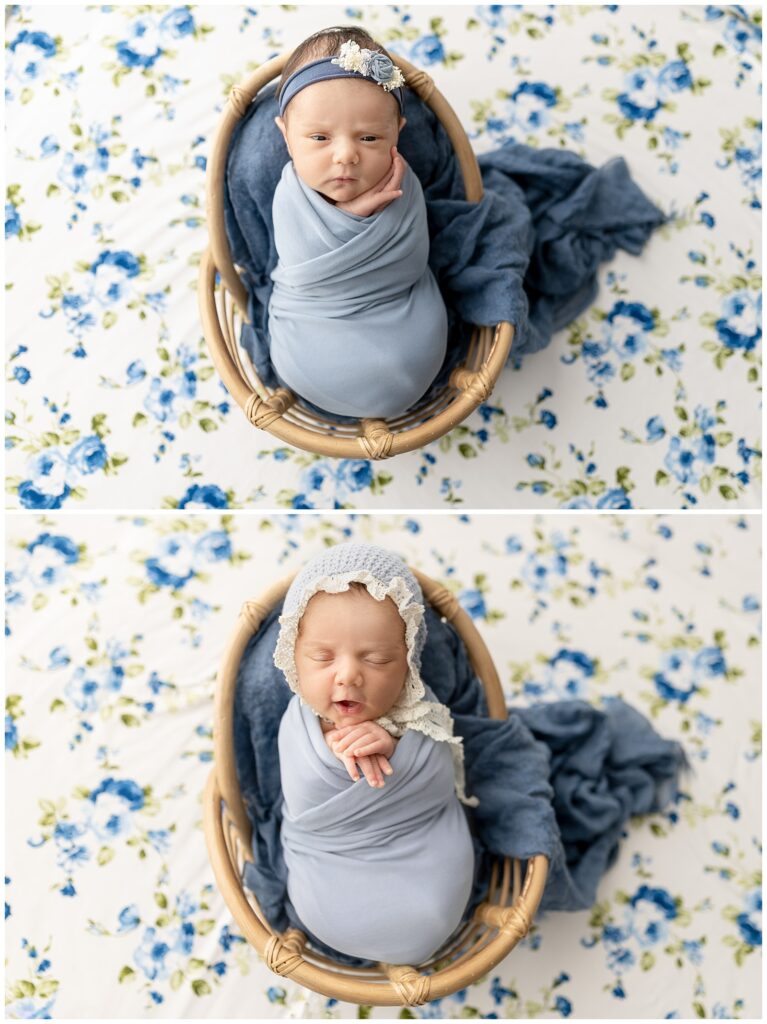 Swaddled baby girl in a blue wrap in a basket with blue flowers on the background