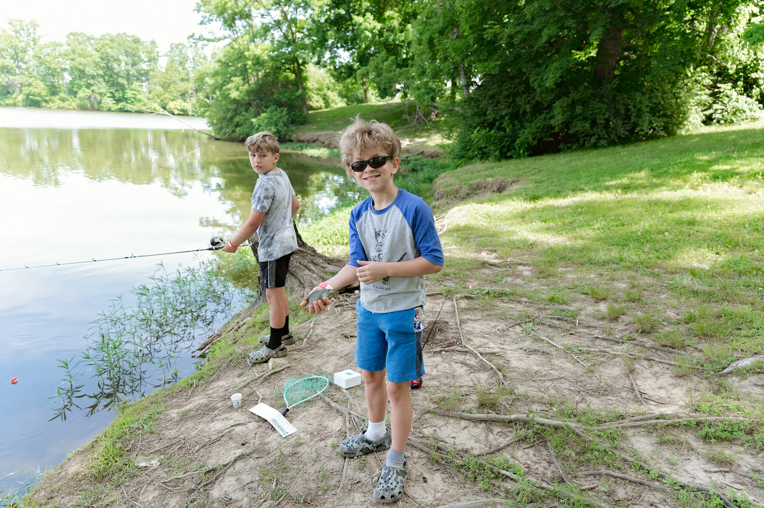 tween boys fishing at the lake